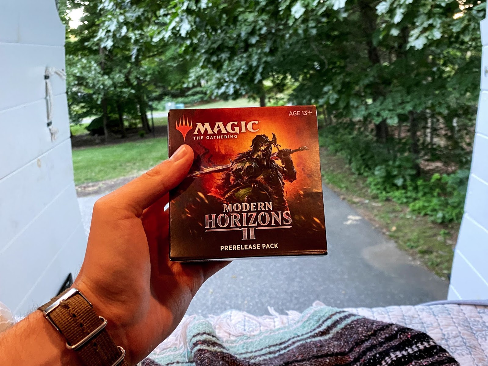 Hand holding up a Modern Horizons 2 prerelease kit.