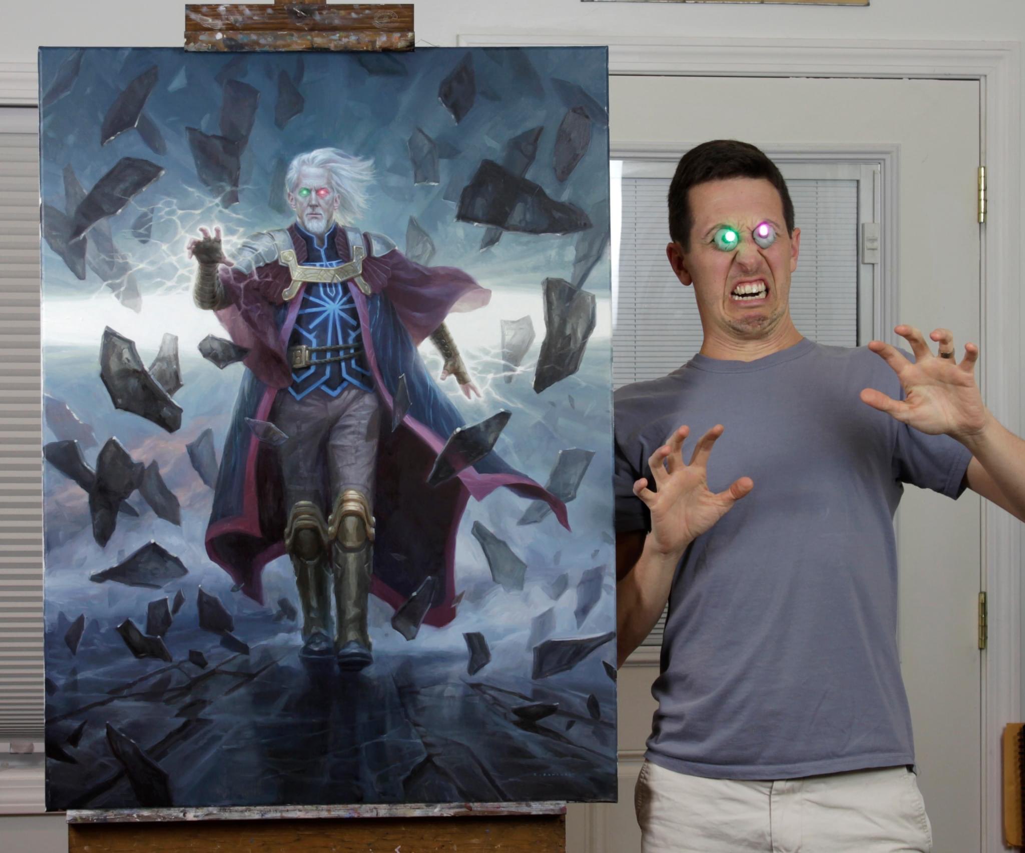 Ryan Pancoast posing beside the art for Urza, Planeswalker