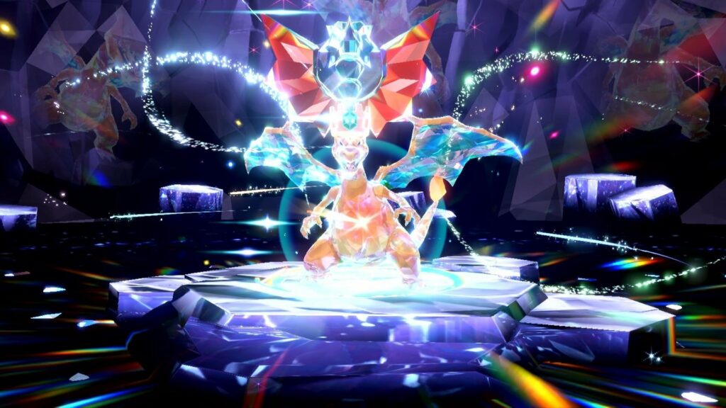 A screenshot from Pokémon Scarlet and Violet shows Charizard, the iconic dragon pokémon, but with its body covered in a crystal-like, multifaceted sheen that projects lights and rainbows all around it. It’s wearing a crystalline crown, which is also in the shape of a more generic dragon head and wings.