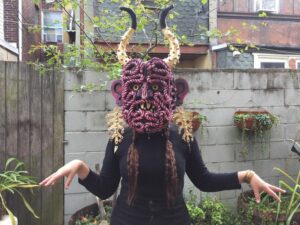 Jeanne D’Angelo, wearing her handmade Humbaba mask