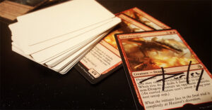 A stack of blank-backed artist proofs. The card on the front side is Glorybringer, the famous dragon from Amonkhet.