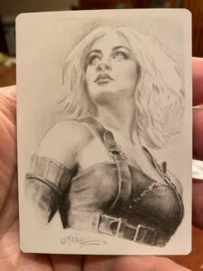 A pencil illustration of the Magic planeswalker, Nahiri. She looks confidently up towards the sky, in leather ironworking clothes with her cropped hair down.