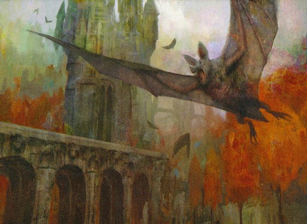 A dark bat flies beside a stone bridge with autumn leaves and a tower behind.