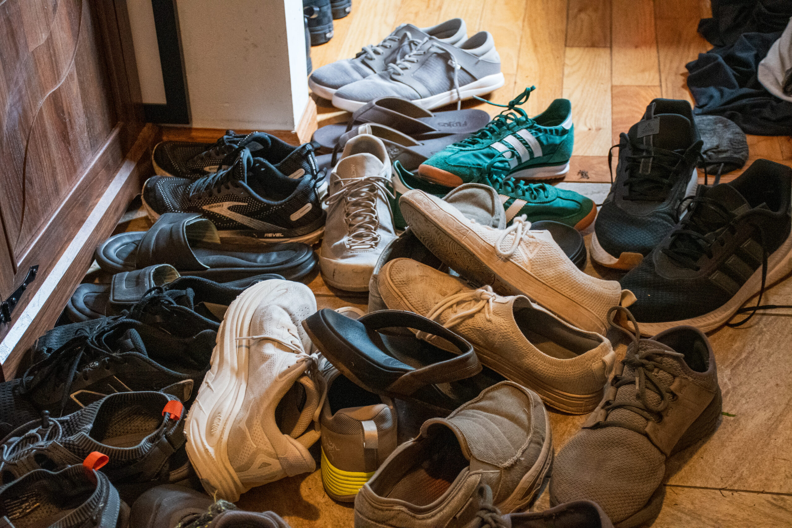 A pile of assorted shoes laid out on the floor