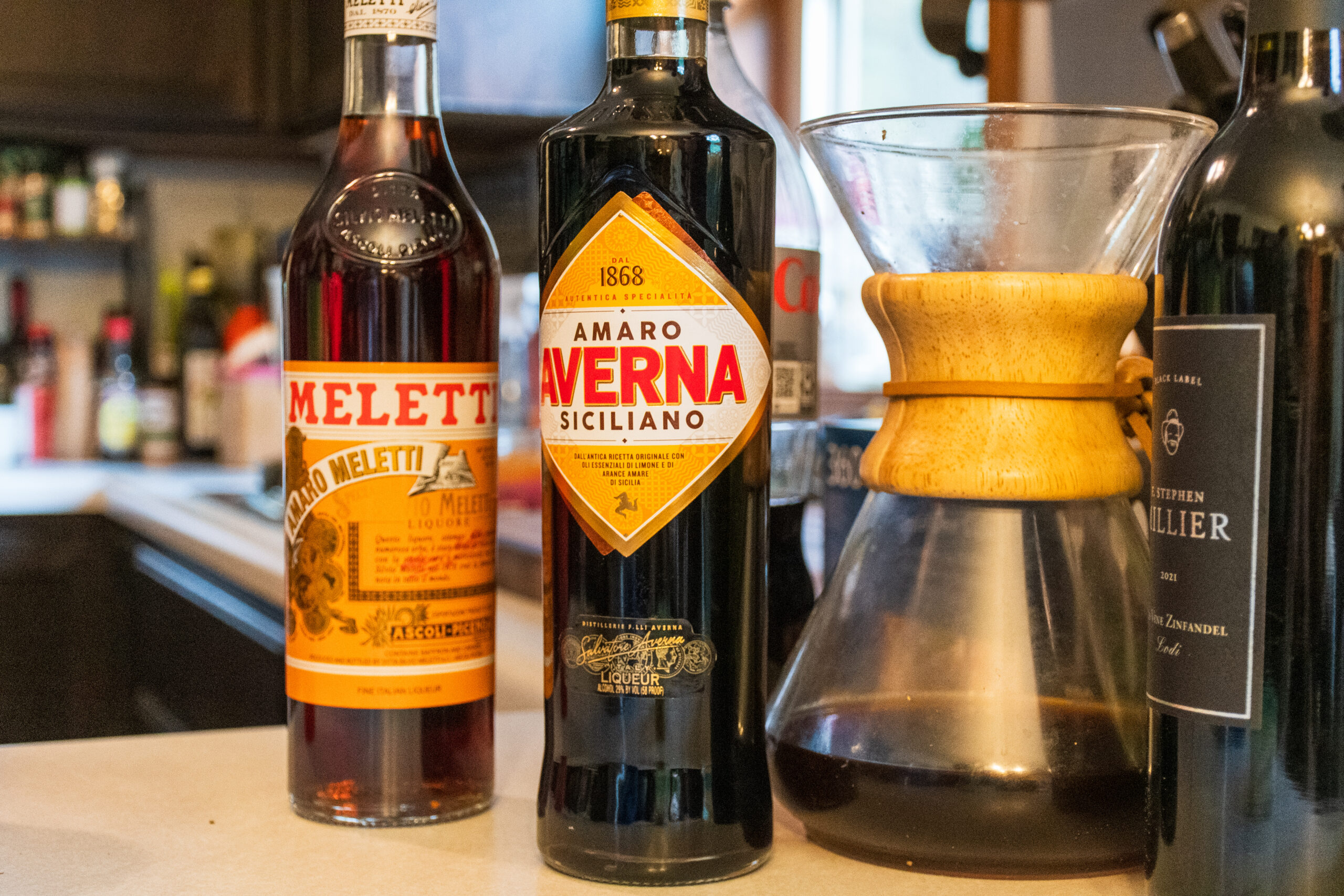 Liquor bottles beside a drip coffee