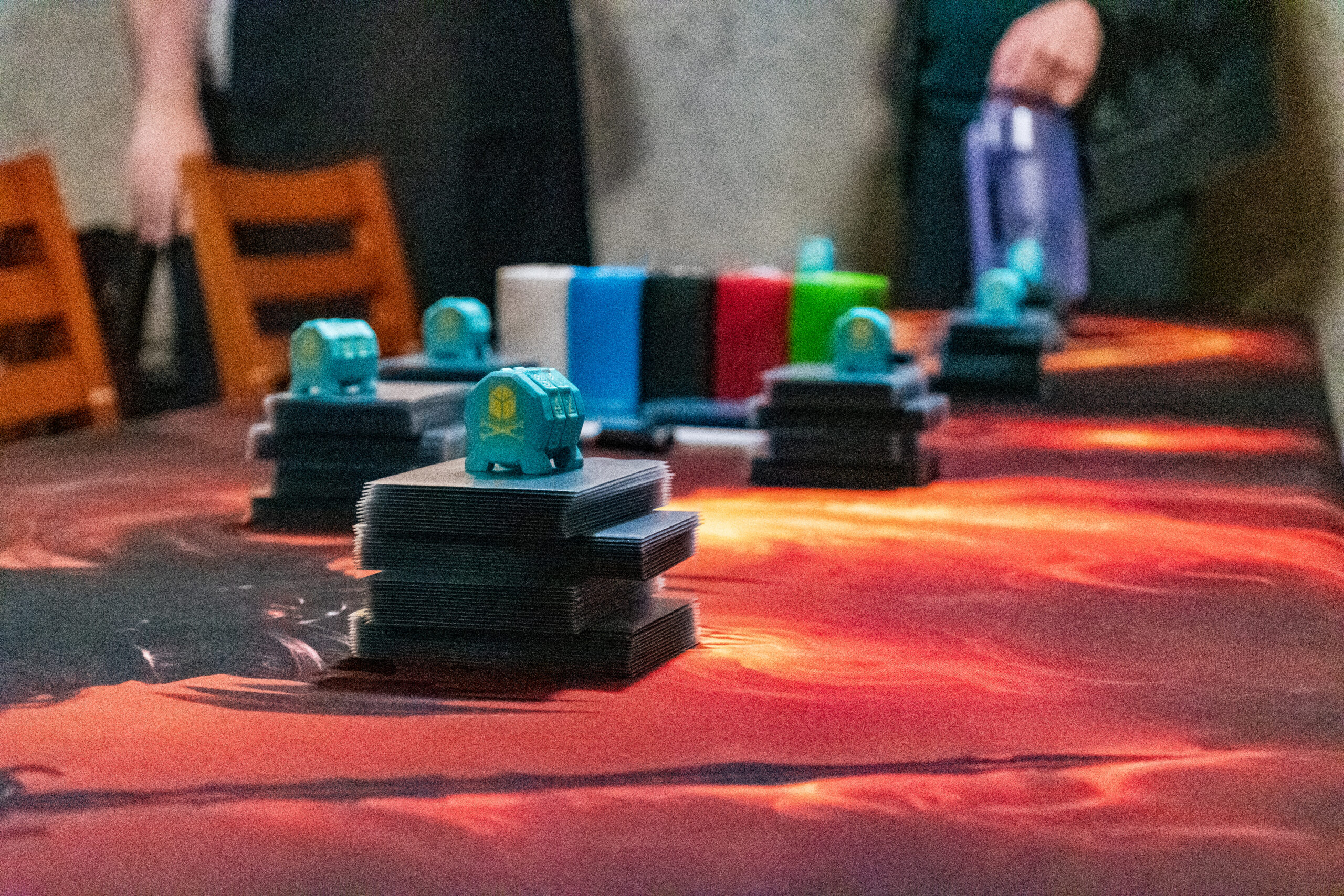 Groups of sleeved Magic cards sorted in neat stacks on a table, each with a life counter on top