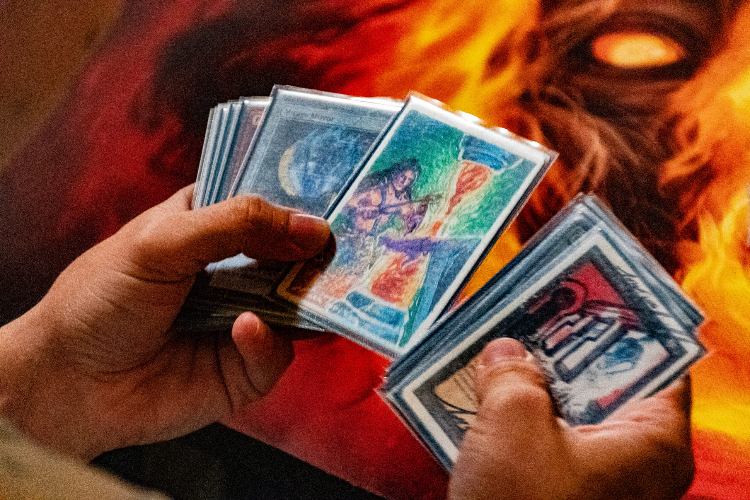 Hands sift through Magic cards, pausing on a full art painting of Timetwister