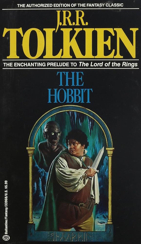 The cover art for the Ballentine Books edition of the Hobbit, featuring a Bilbo character that looks like a community theater stage production, complete with a wig that doesn't appear natural for their head. The cover is black with yellow and green text for the titles.